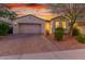 Charming single-story home featuring a two-car garage and attractive desert landscaping at 13720 W Amberwing St, Peoria, AZ 85383
