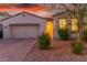 Charming single-story home featuring a two-car garage and attractive desert landscaping at 13720 W Amberwing St, Peoria, AZ 85383