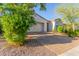 Inviting single-story home boasting a brick driveway, two-car garage, and well-maintained landscaping at 13720 W Amberwing St, Peoria, AZ 85383