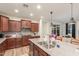 Well-equipped kitchen featuring a large island, stainless steel appliances, and dark wood cabinets at 13720 W Amberwing St, Peoria, AZ 85383