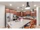 Spacious kitchen with a large island, stainless steel appliances, and dark wood cabinetry at 13720 W Amberwing St, Peoria, AZ 85383