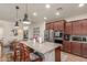 Modern kitchen with granite countertops, stainless steel appliances, and a center island with bar seating at 13720 W Amberwing St, Peoria, AZ 85383