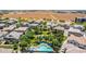 Aerial view of a neighborhood featuring a community pool and playground in a green common area at 14870 W Encanto Blvd # 1061, Goodyear, AZ 85395