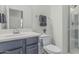 Well-lit bathroom features a gray vanity with white countertops and a glass-enclosed shower at 14870 W Encanto Blvd # 1061, Goodyear, AZ 85395