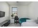 Bedroom features a desk, a beanbag chair, and a bed, complemented by a media center at 14870 W Encanto Blvd # 1061, Goodyear, AZ 85395