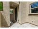 Inviting entrance with textured walls, a black door, and a 
