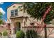 Beautiful two-story home enhanced by vibrant desert landscaping, a gate, and a tidy walkway at 14870 W Encanto Blvd # 1061, Goodyear, AZ 85395