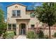 Inviting two-story home with lush desert landscaping, charming gate and well-maintained walkway at 14870 W Encanto Blvd # 1061, Goodyear, AZ 85395