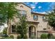 Charming two-story home with lush desert landscaping and a gate leads to a well-maintained walkway at 14870 W Encanto Blvd # 1061, Goodyear, AZ 85395