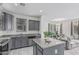 Modern kitchen features gray cabinets, granite countertops, stainless steel appliances, and an island at 14870 W Encanto Blvd # 1061, Goodyear, AZ 85395