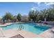 Outdoor community pool with lounge chairs and manicured landscaping on a clear, sunny day at 14870 W Encanto Blvd # 1061, Goodyear, AZ 85395