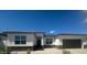 Contemporary single-story home featuring stucco siding, decorative stone accents, and a spacious two-car garage at 15386 W Cottontail Ln, Surprise, AZ 85387