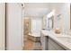 Bright bathroom with soaking tub, tiled shower, and double sink vanity with gray cabinetry at 15815 N 4Th Dr, Phoenix, AZ 85023