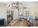Dining area overlooking living room and kitchen features stylish furnishings and modern, industrial lighting at 15815 N 4Th Dr, Phoenix, AZ 85023
