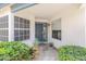 Inviting front porch with security screen door flanked by ample windows and lush, mature landscaping at 15815 N 4Th Dr, Phoenix, AZ 85023