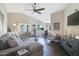 Bright living room features vaulted ceiling, ceiling fan, hardwood floors and stylish, comfortable furniture at 15815 N 4Th Dr, Phoenix, AZ 85023