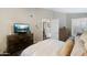 Well-lit primary bedroom featuring a dresser, TV, and serene decor at 15815 N 4Th Dr, Phoenix, AZ 85023