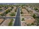 High aerial neighborhood shot of single Gathering homes with desert landscaping and a street view at 15902 W Hearn Rd, Surprise, AZ 85379