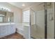 Bright bathroom with a jetted tub, glass-enclosed shower, and dual vanity sinks at 15902 W Hearn Rd, Surprise, AZ 85379