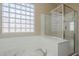 Bathroom showcasing a modern jetted tub and a glass-enclosed shower at 15902 W Hearn Rd, Surprise, AZ 85379