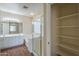 Bright bathroom featuring dual vanities, a glass-enclosed shower, and a soaking tub at 15902 W Hearn Rd, Surprise, AZ 85379