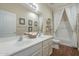 Bright bathroom with dual sinks, white cabinets, and bathtub at 15902 W Hearn Rd, Surprise, AZ 85379