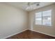 Bright bedroom featuring a window, ceiling fan, and wood-look flooring at 15902 W Hearn Rd, Surprise, AZ 85379