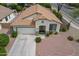 Aerial view of a charming single-Gathering home featuring a well-manicured lawn and spacious driveway at 15902 W Hearn Rd, Surprise, AZ 85379