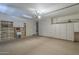 Large garage with built-in cabinets and a utility sink for convenience at 15902 W Hearn Rd, Surprise, AZ 85379