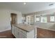 Kitchen island with white cabinets and great natural light at 15902 W Hearn Rd, Surprise, AZ 85379