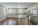 Spacious kitchen with stainless steel appliances, white cabinets, and center island at 15902 W Hearn Rd, Surprise, AZ 85379