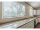 Bright kitchen featuring white cabinets and stainless steel appliances, illuminated by natural light at 15902 W Hearn Rd, Surprise, AZ 85379