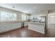 Modern kitchen featuring white cabinets, island, and stainless steel appliances at 15902 W Hearn Rd, Surprise, AZ 85379