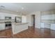 Modern kitchen featuring stainless steel appliances, island, and white cabinetry at 15902 W Hearn Rd, Surprise, AZ 85379