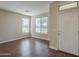 Bright, airy living room with hardwood floors and plenty of natural light from large windows at 15902 W Hearn Rd, Surprise, AZ 85379