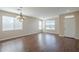 Well-lit living room featuring wood floors and multiple windows at 15902 W Hearn Rd, Surprise, AZ 85379