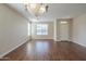 Bright, open living room featuring wood floors, natural light, and neutral paint at 15902 W Hearn Rd, Surprise, AZ 85379