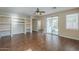 Bright living room featuring wood-look floors and a large sliding glass door to the patio at 15902 W Hearn Rd, Surprise, AZ 85379
