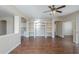Bright open-plan living space with wood-look floors and custom built-in shelving and arches at 15902 W Hearn Rd, Surprise, AZ 85379