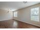 Spacious living room with wood floors, multiple windows and neutral paint at 15902 W Hearn Rd, Surprise, AZ 85379