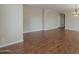 Spacious living room with hardwood flooring and neutral paint, offering a versatile living space at 15902 W Hearn Rd, Surprise, AZ 85379
