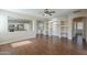 Bright living room featuring an archway to the kitchen, wood flooring, and built-in shelves at 15902 W Hearn Rd, Surprise, AZ 85379