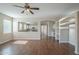 Open-concept living room featuring archway to the kitchen and wood-look floors at 15902 W Hearn Rd, Surprise, AZ 85379