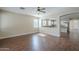 Open concept living space with kitchen view, ceiling fan, and wood-look flooring at 15902 W Hearn Rd, Surprise, AZ 85379