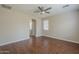 Neutral bedroom with wood-look floors, a ceiling fan, and an ensuite bathroom at 15902 W Hearn Rd, Surprise, AZ 85379