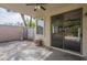Covered patio featuring tiled flooring and a sliding glass door to the interior at 15902 W Hearn Rd, Surprise, AZ 85379