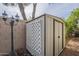 Outdoor shed featuring a sturdy construction, lattice detailing, and a lamp post at 15902 W Hearn Rd, Surprise, AZ 85379