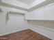 Well-organized walk-in closet with ample shelving and laminate floors at 15902 W Hearn Rd, Surprise, AZ 85379