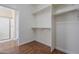 Bright walk-in closet showing laminate flooring, shelving and access to bathroom at 15902 W Hearn Rd, Surprise, AZ 85379