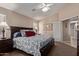 Cozy bedroom boasts a queen bed, dark wood furnishings, and a view into the ensuite bathroom at 16280 W Durango St, Goodyear, AZ 85338